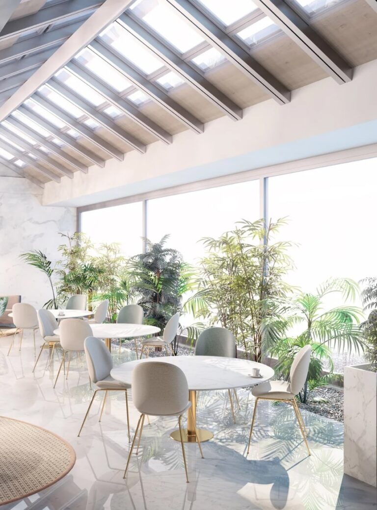 Light office space with circular tables and grey chairs surrounding each one